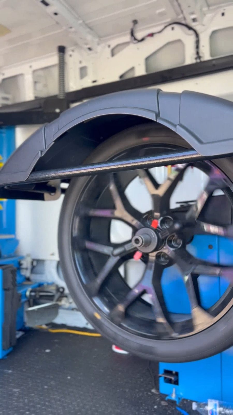 Custom wheel on the balancer inside the Donut Mobile Tire van